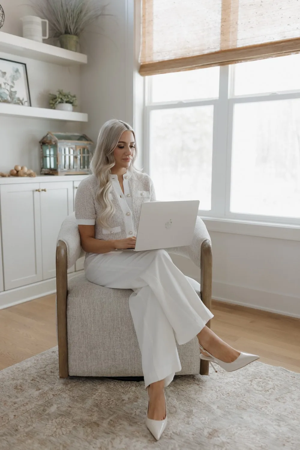 Marissa Lubera working from a sunlit living room